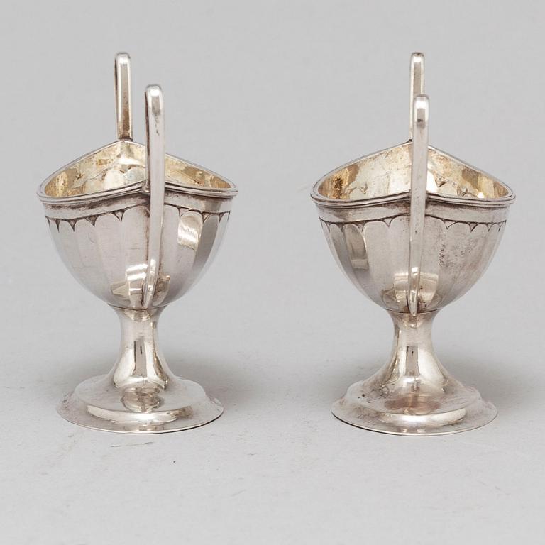 A pair of parcel-gilt empire silver salt cellars, 19th century.