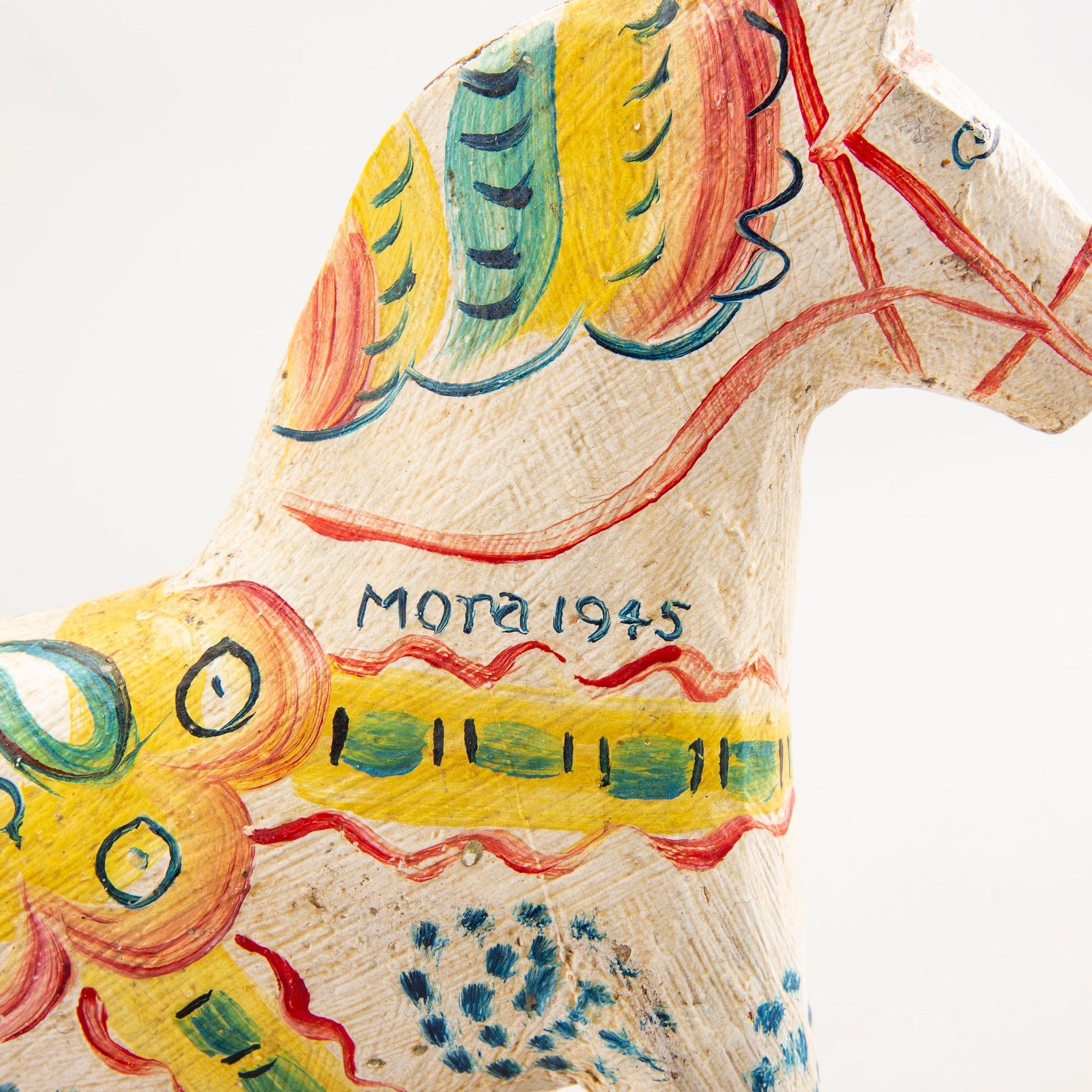 A Swedish painted and dated 1945 wooden horse.