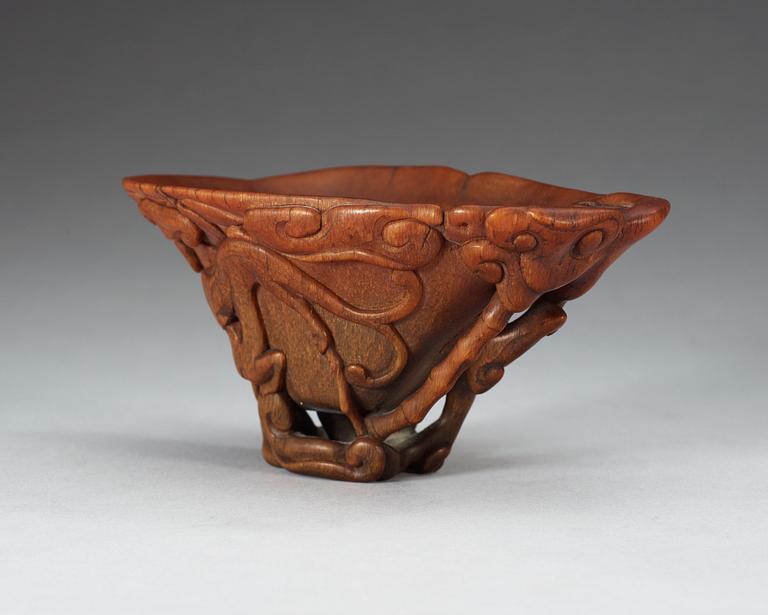 A finely carved rhinoceros libation cup, Qing dynasty, Kangxi (1662-1722).