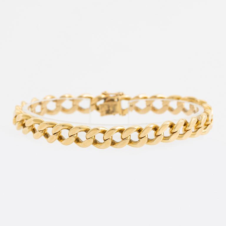 18K gold curb link bracelet.