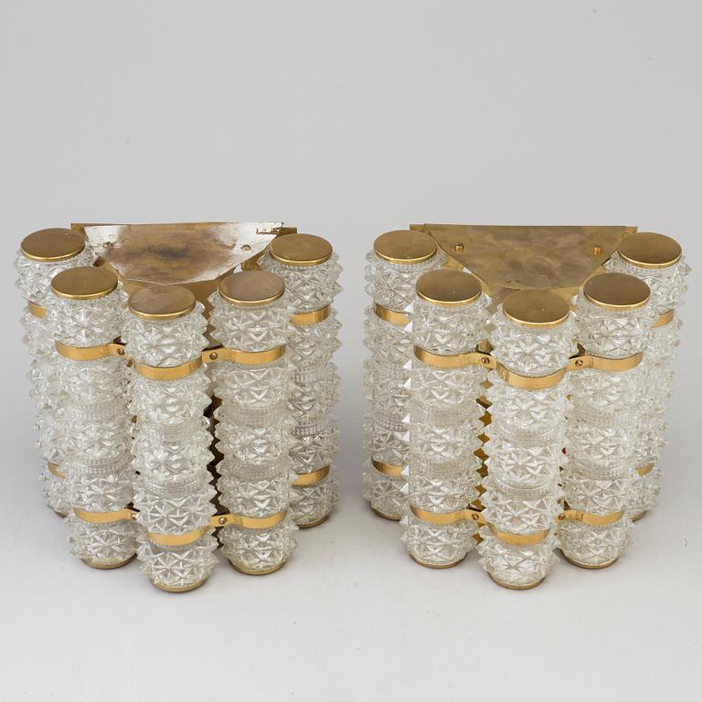 A pair of 1970's glass and brass wall lamps.