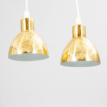 A pair of Hans-Agne Jakobsson brass ceiling pendants.