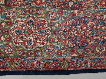 A CARPET. A semi-antique Kerman. 614,5 x 360,5 cm.