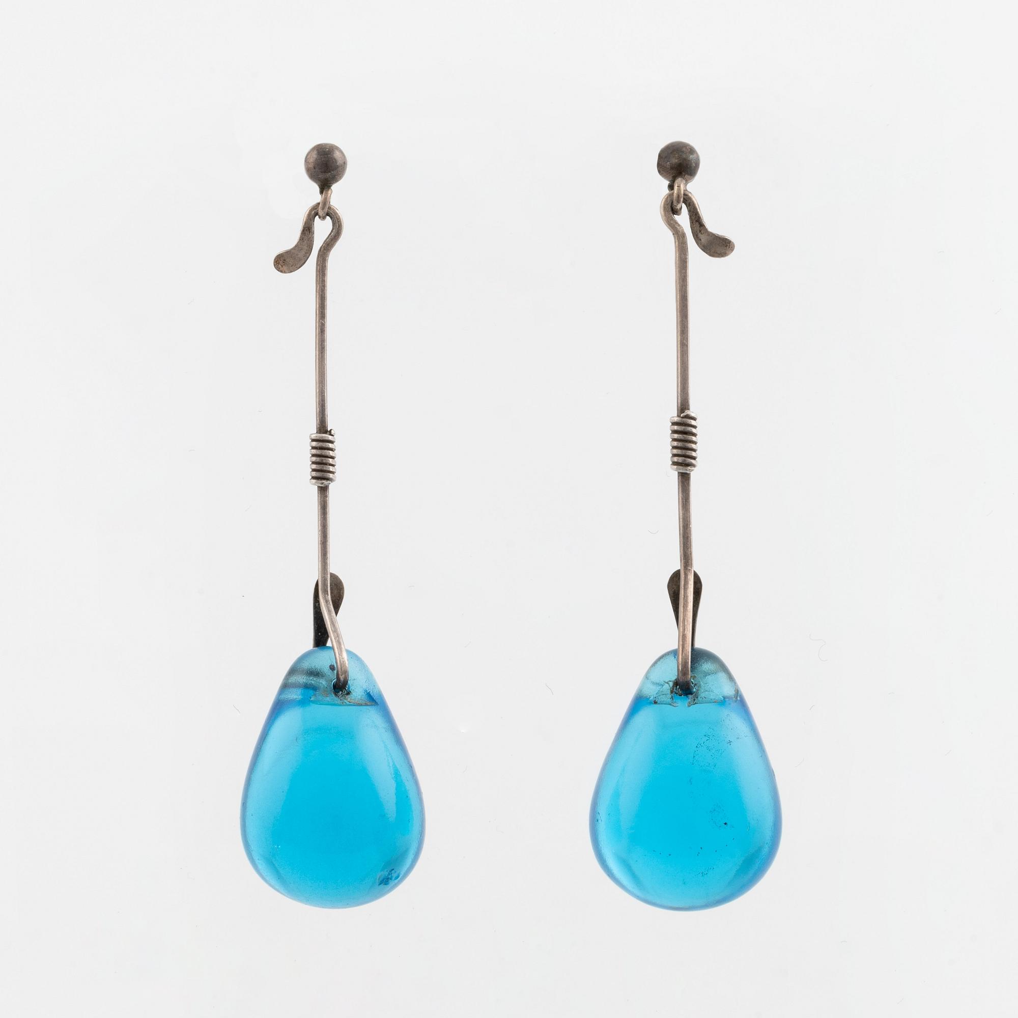 A pair of silver earrings with blue glass drops, likely by Torun Bülow-Hübe.