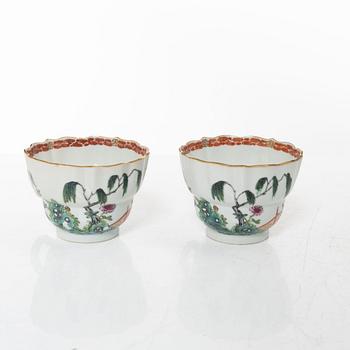A pair of Chinese famille rose teacups with saucers and a pair of plates and two dishes, Qing dynasty, 18th century.