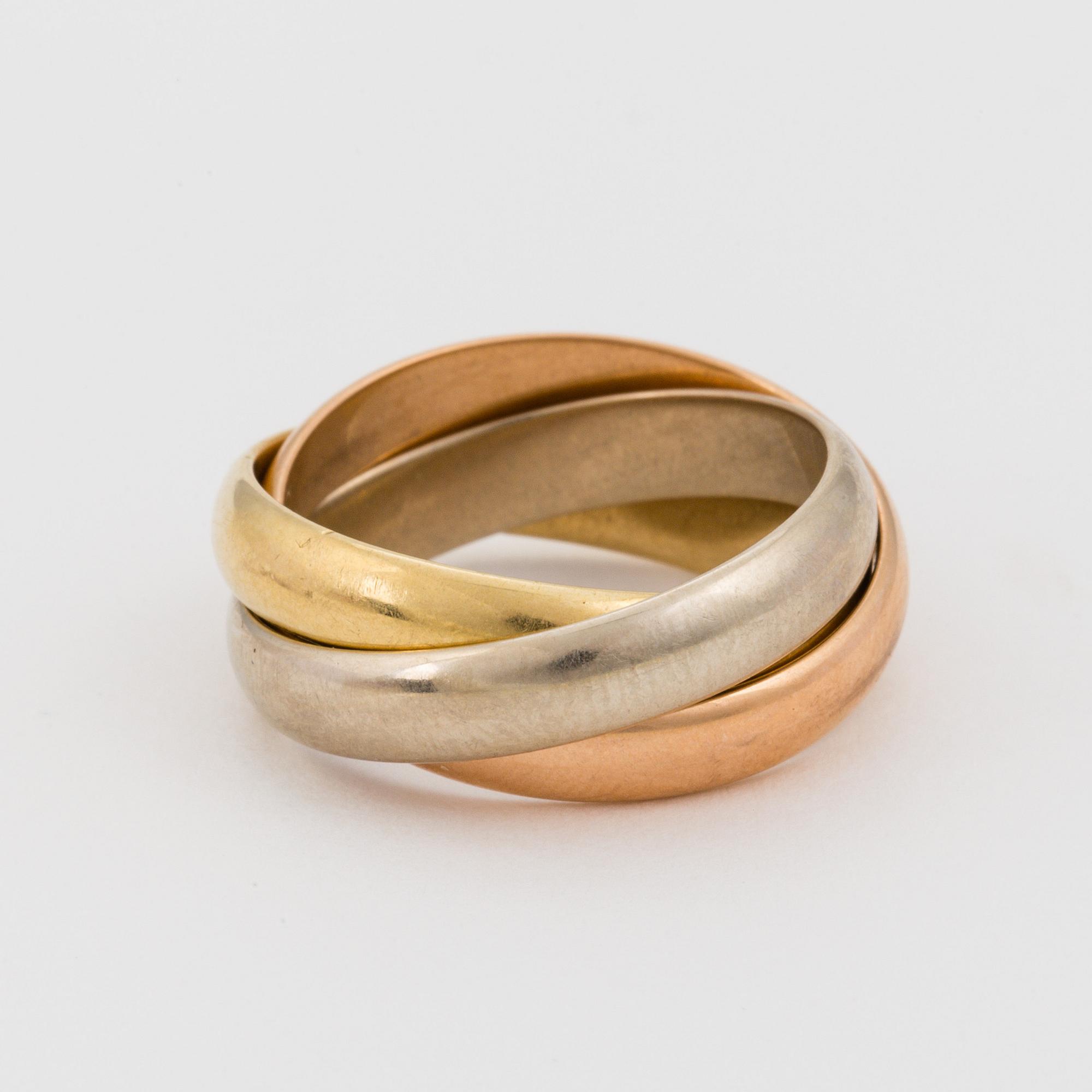An 18K white, rose and yellow gold ring.