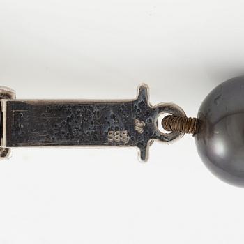 Necklace of cultured freshwater pearls, clasped with 14K white gold and round brilliant-cut diamonds.