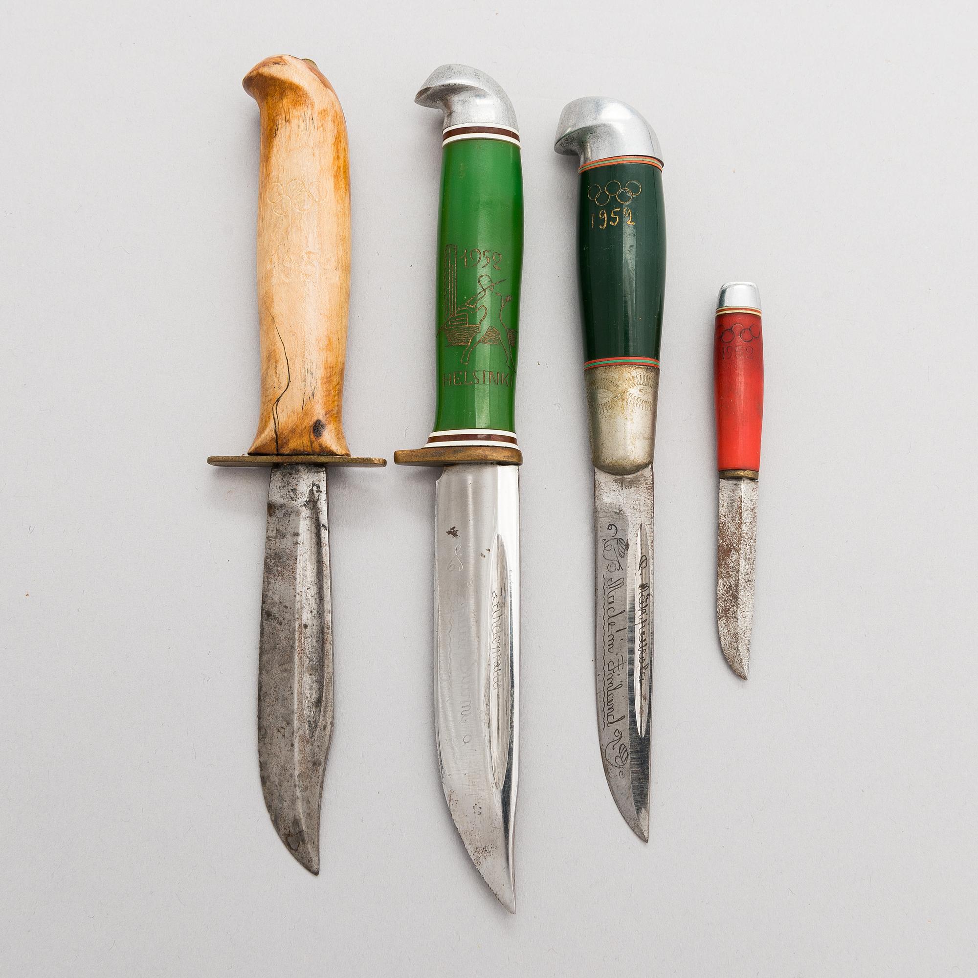 A set of four puukko knives and leather sheats, marked Olympia Helsinki -52.