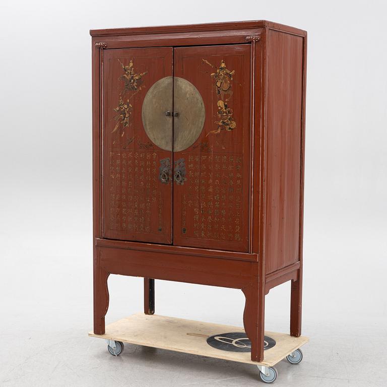 A red lacquered cabinet, China, early 20th century.