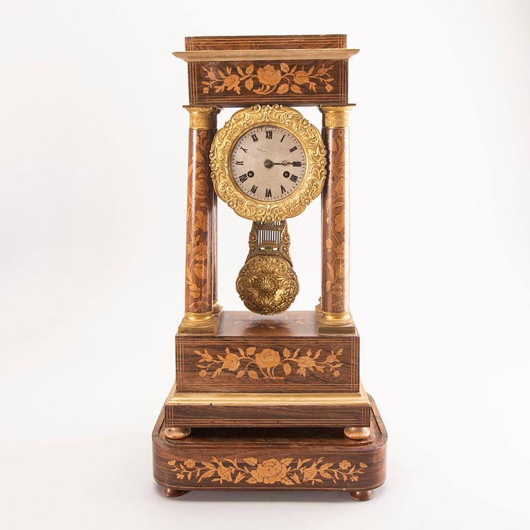 A late Empire mid 19th century veneered table clock.