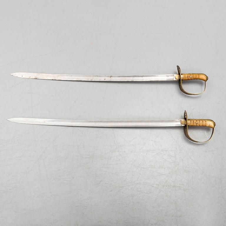 Two cavalry sabres 1867 pattern with scabbards.