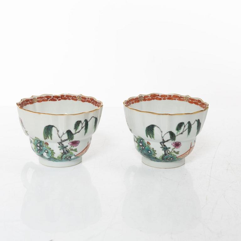 A pair of Chinese famille rose teacups with saucers and a pair of plates and two dishes, Qing dynasty, 18th century.