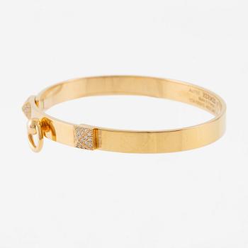 Hermès a bangle "Collier de chien" in 18K gold with round brilliant-cut diamonds.