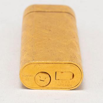 A gilt steel lighter from les must de Cartier.