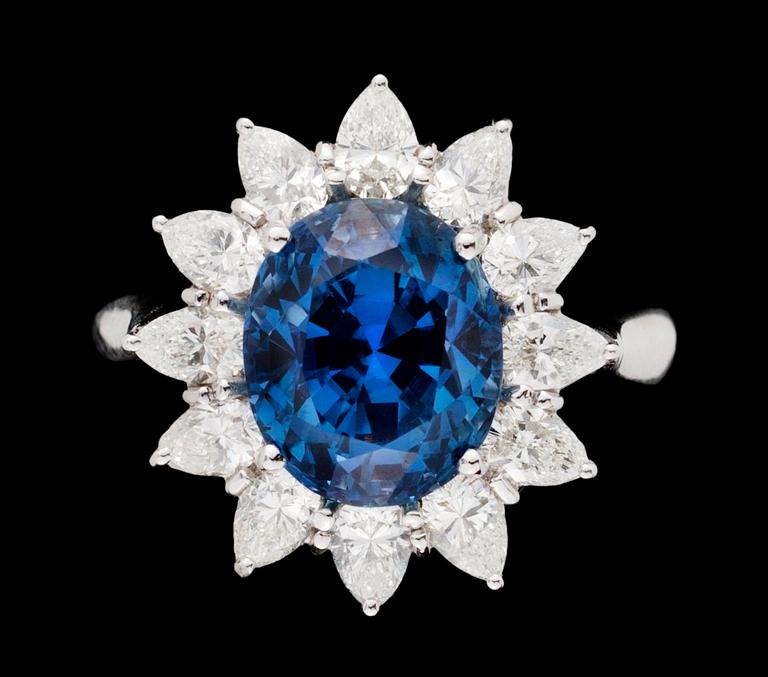 A gold, blue sapphire and diamond ring.