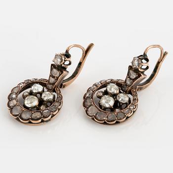 A pair of earrings set with rose-cut diamonds.