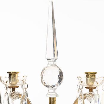 A pair of brass and glass canelabras, first half of the 20th century.