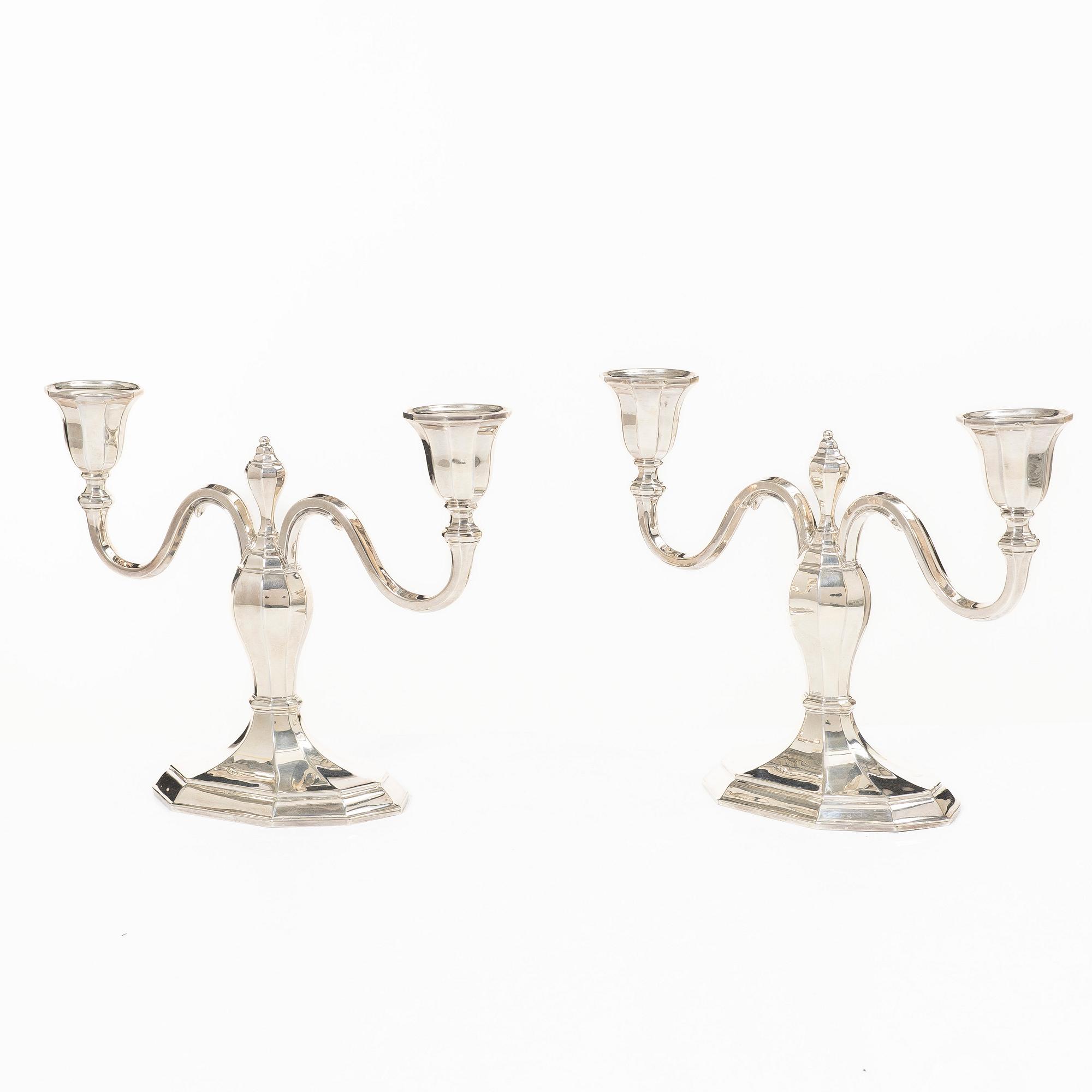 A pair of silver candelabras, with Swedish import marks, possibly mid20th century.