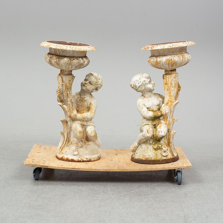 An end of the 20th Century pair of cast iron flower pots.