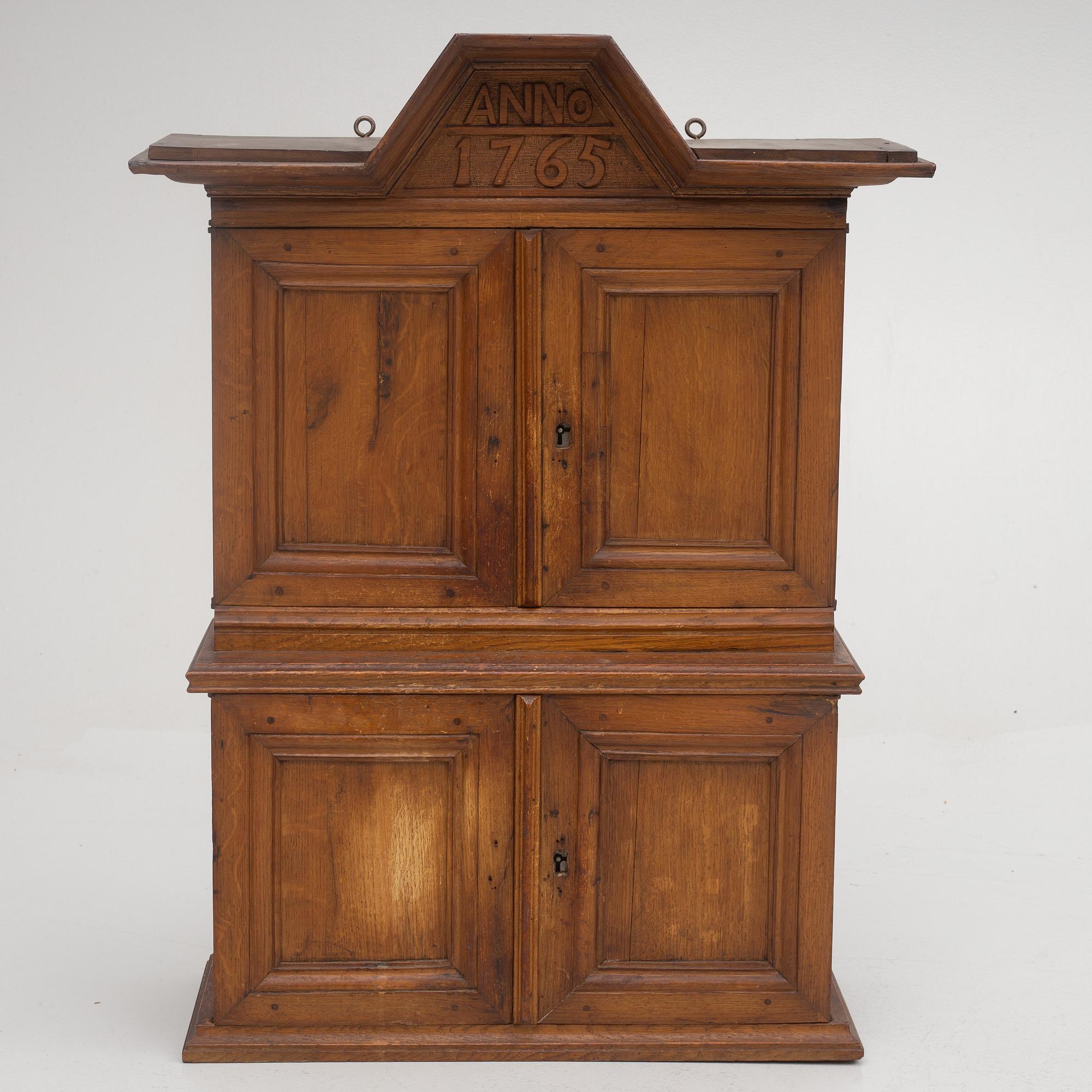 A wall cabinet, dated 1765.