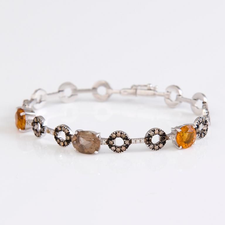 An 18K white gold bracelet with citrines, smoky quartz and diamonds.