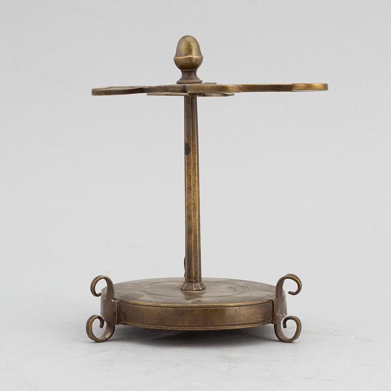 A 18th Century brass candle holder.