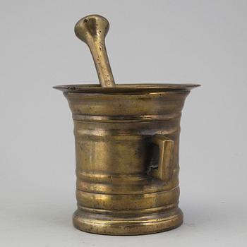 A 18th century brass mortar with pestle.