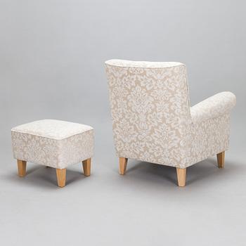 A mid-20th-century armchair and ottoman.