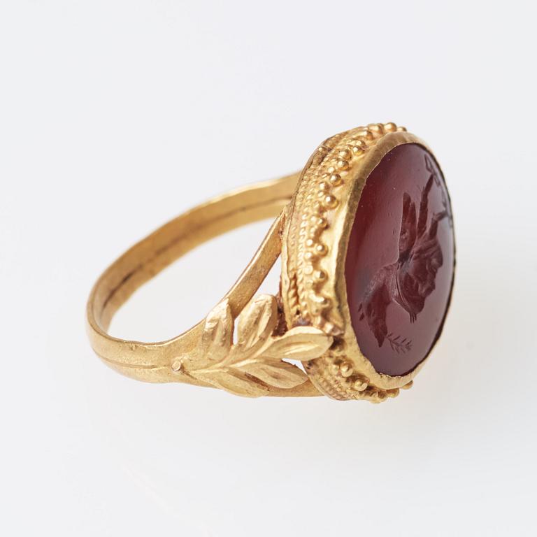 A possibly Etruscan gold and carnelian signet ring.