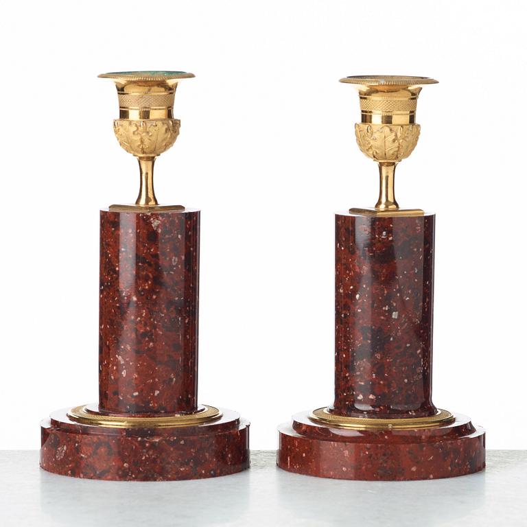 Two matched of 19th century Empire-style porphyry  candlesticks.