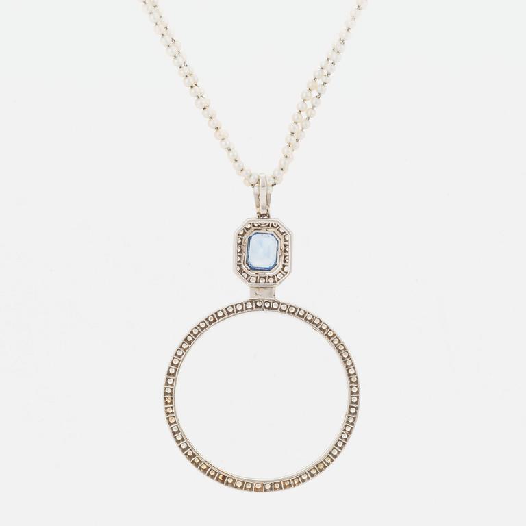 A platinum lorgnette set with a faceted sapphire and rose-cut diamonds.