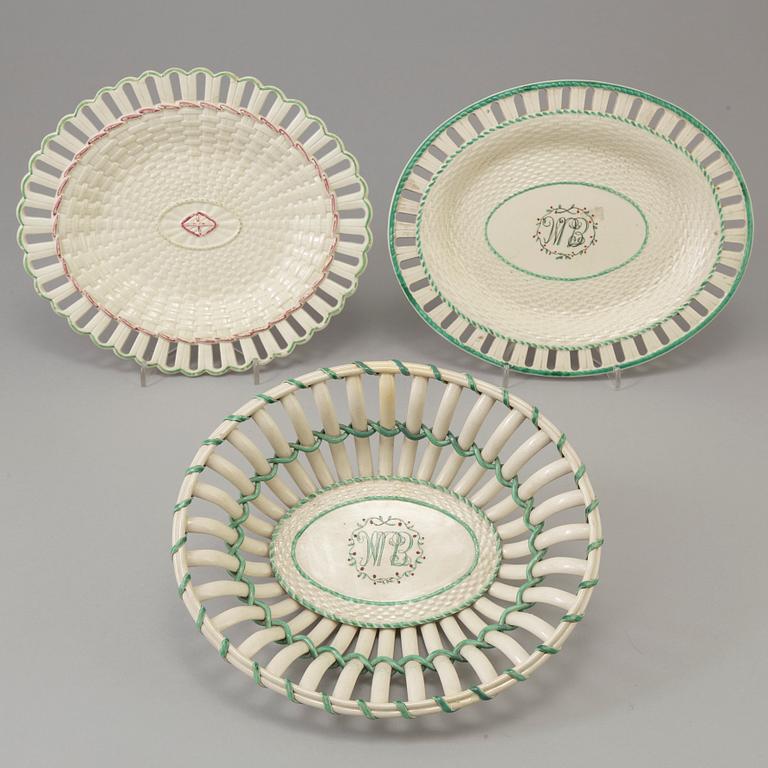 A CREAMWARE BASKET, PLATE AND A SIMILAR PLATE, one marked Wedgwood, first half of the 19th century.