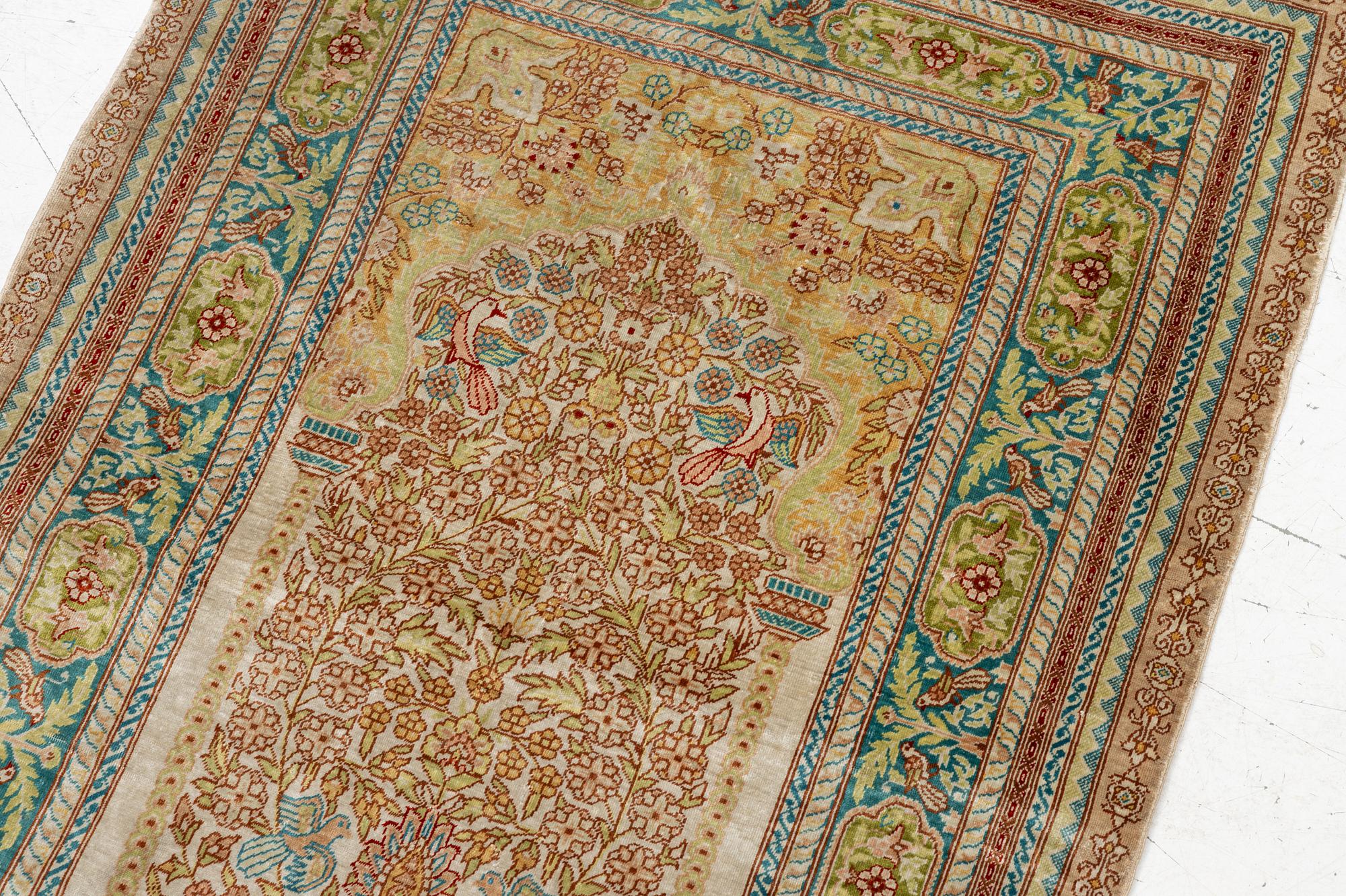 A semi-antique silk Hereke, c. 92 x 61 cm.