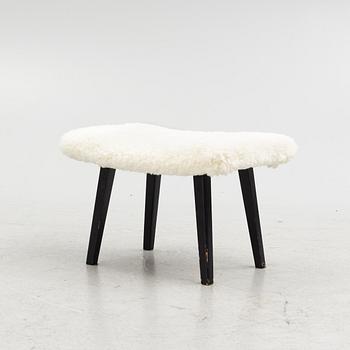 A mid 20th Century stool with sheepskin upholstery.