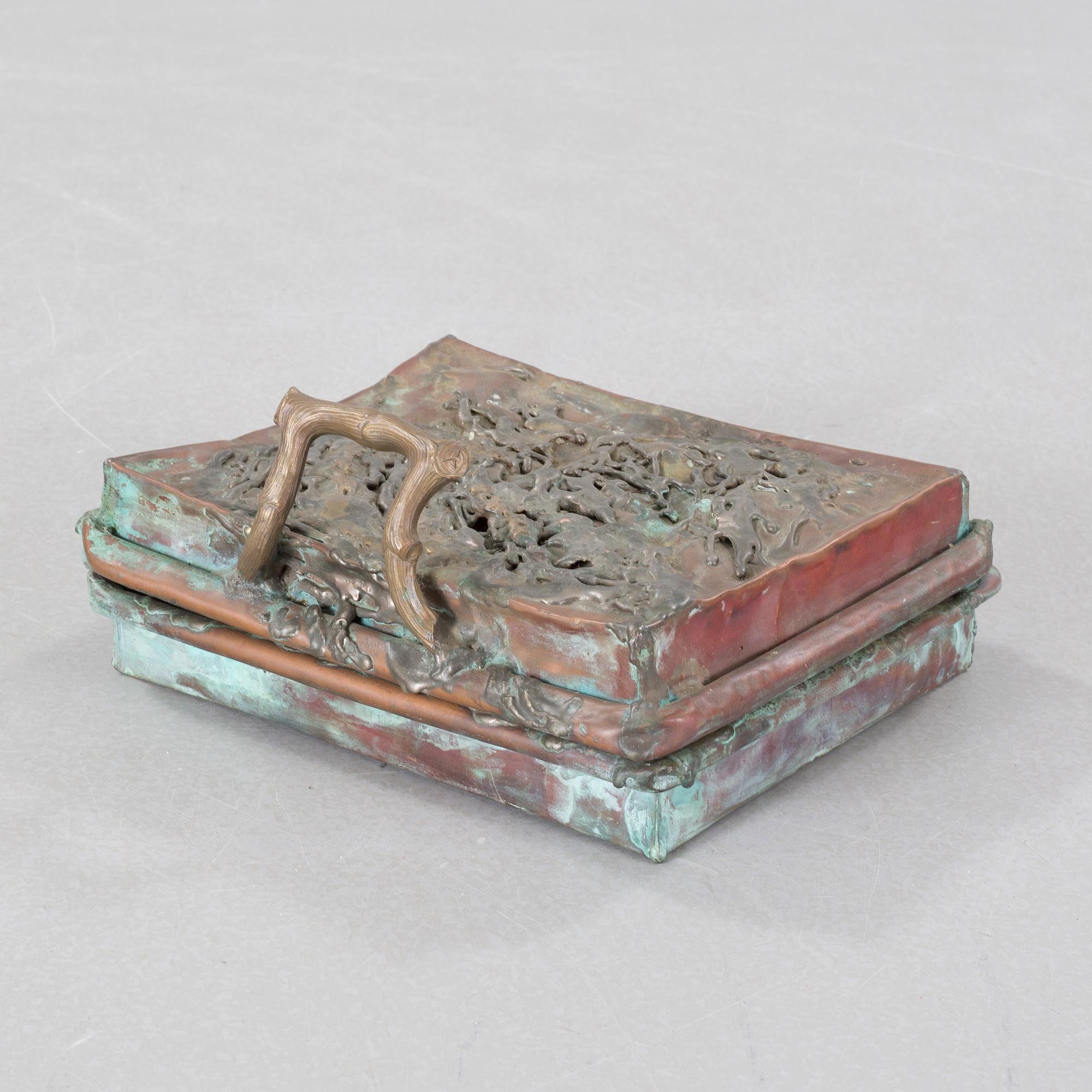 a metal sculpture, signed and dated -83.