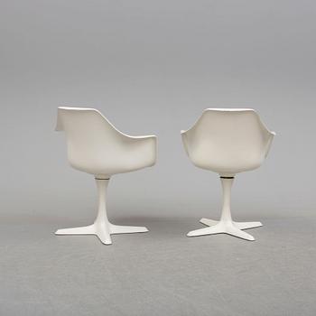 A dining table and eight chairs by Robin Day, Arkana.