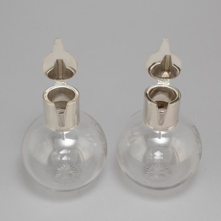 A pair of caraffes with silver mountings by CG Hallberg, Stockholm 1890.