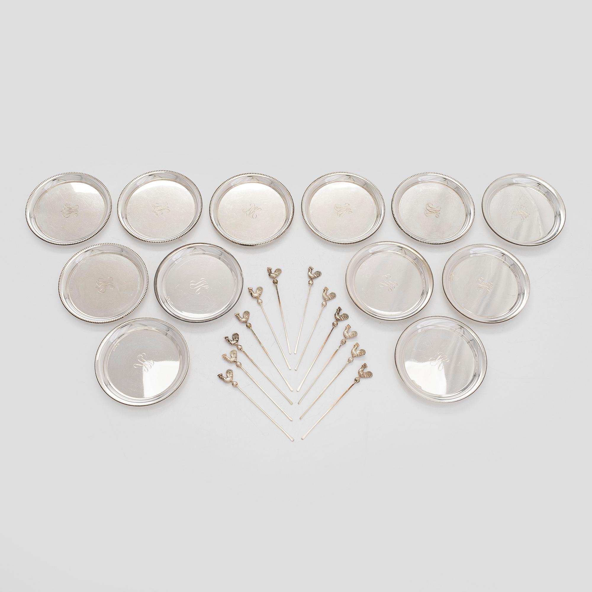 A set of 12 silver glass coasters, Auran Kultaseppä Oy Turku 1935 and 1983, and cocktail sticks, 12 pcs silver.
