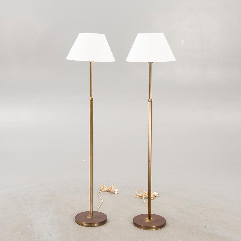 A pair of brass floor lamps from NK (Nordiska Kompaniet) later part of the 20th century.