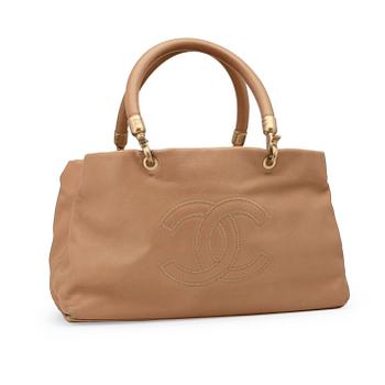CHANEL, a beige leather handbag.