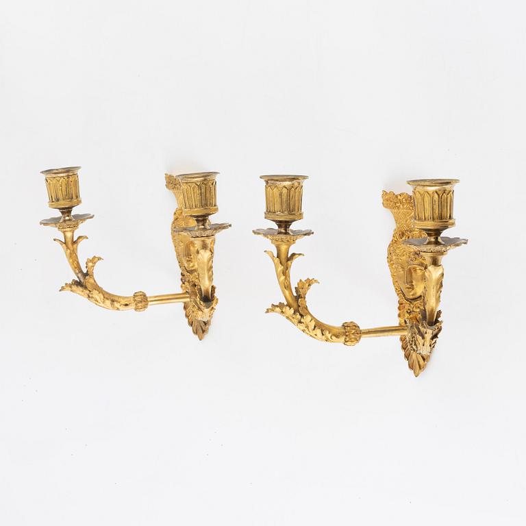 A pair of Empire-style ormolu two-light wall lights, 19th Century.
