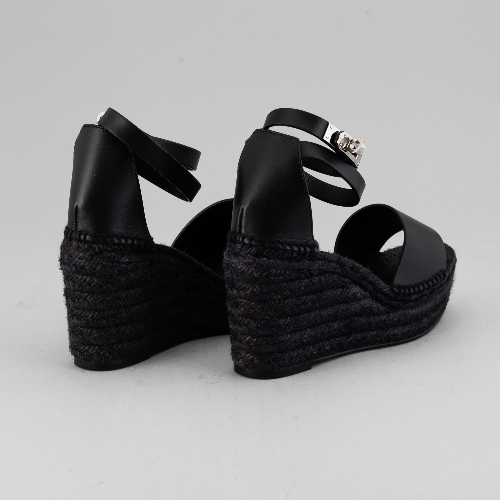 HERMÈS, a pair of black leather 'Tivoli' wedge sandals, 2019, size 38.