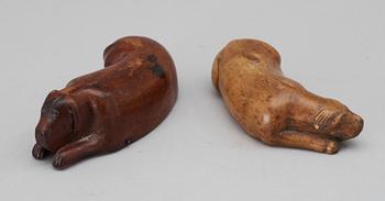 Two 19th-20th century birch snuffboxes in the shape of lying dogs.