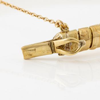 A bracelet in the shape of a serpent in 18K gold with a faceted citrine and rose-cut diamonds.