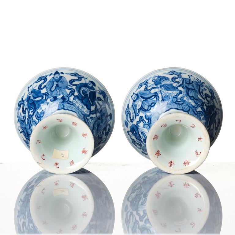 A pair of blue and white 'eight immortals' stemcups, Qing dynasty with Daoguang mark and of the period.
