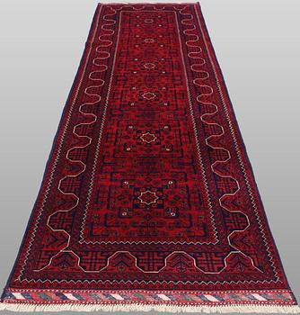 A Afghan runner carpet, 304 x 84 cm.
