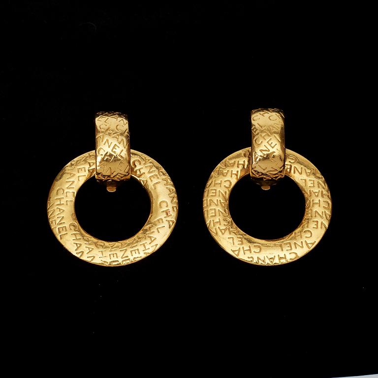 A pair of earrings by Chanel.
