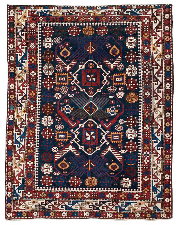 A RUG. A semi-antique Kuba/Shirvan. 165,5 x 129,5 cm (as well as one end with one cm flat weave).