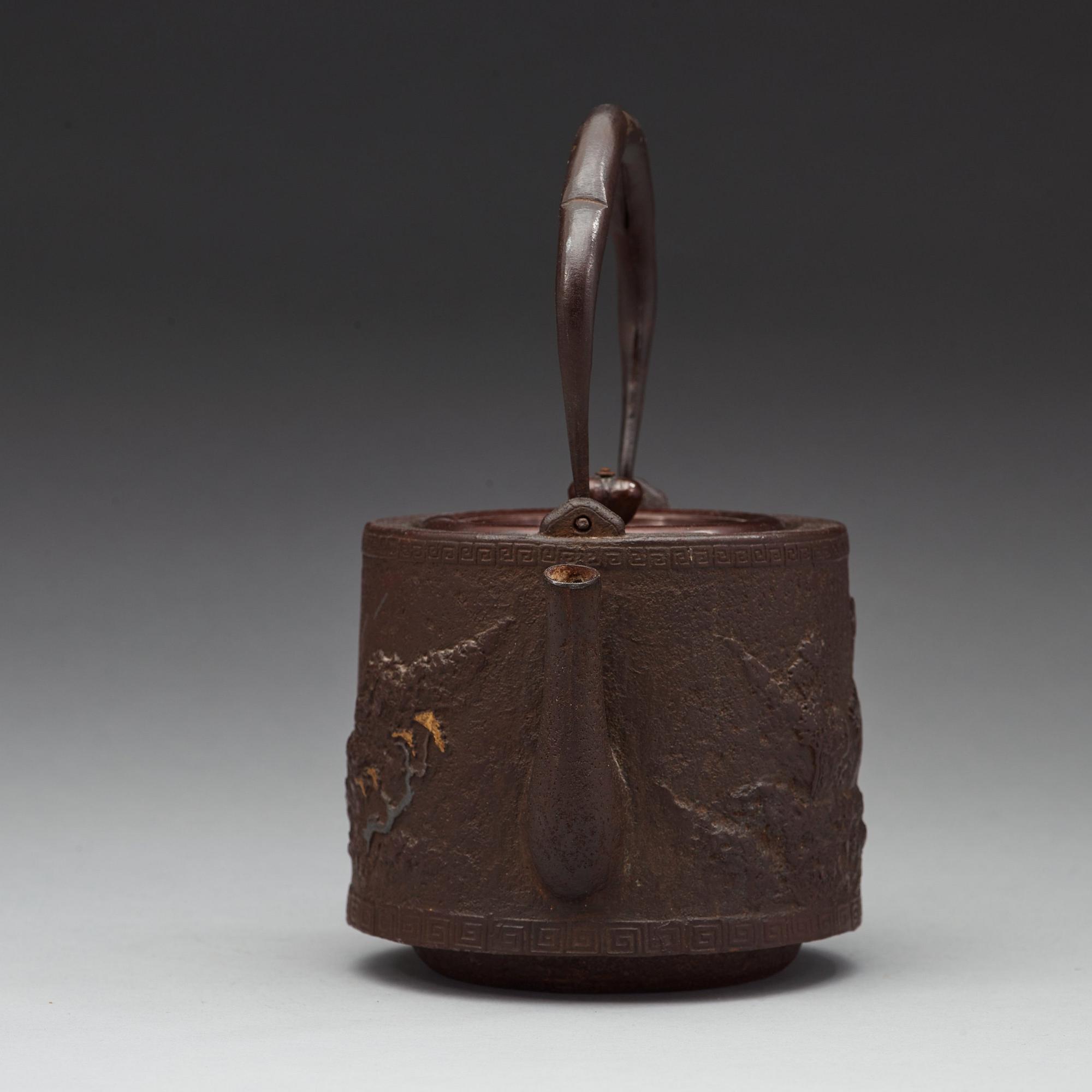 A Japanese iron and bronze tea pot with cover, Meiji period 1868-1912).