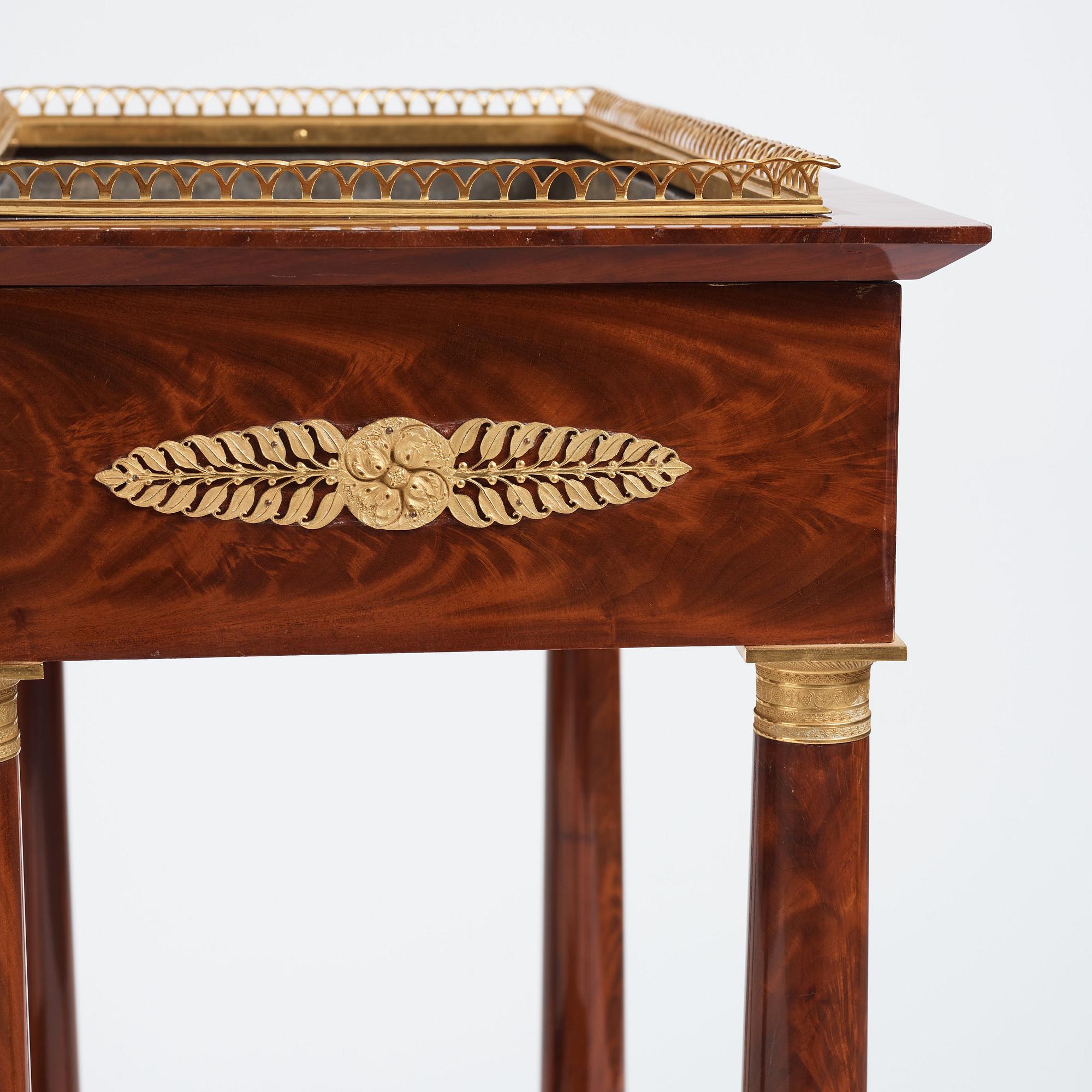 A pair of French Empire gilt bronze-mounted mahogany jardinieres, first half of the 19th century.